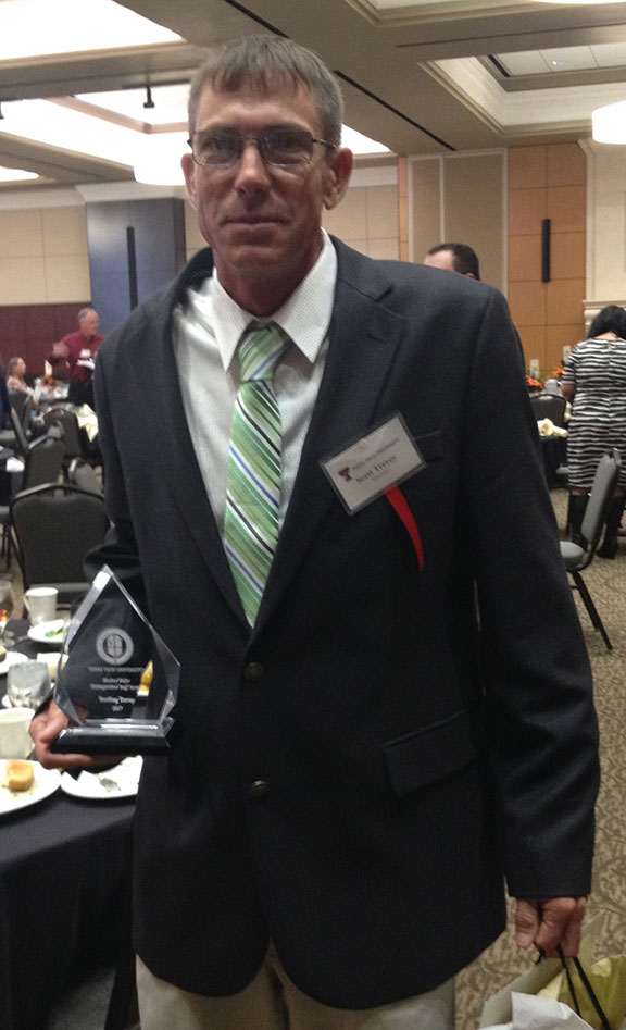 Scott Trevey holding staff award